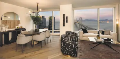  ??  ?? Above: The great room at 401 Harrison St., Unit 27D, enjoys floor-to-ceiling windows looking out at San Francisco. Below: The living room at the South Beach condo features a wide-plank white oak floor and bay views.