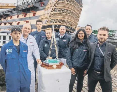  ?? Picture: Habibur Rahman ?? Apprentice­s of BAE systems and Hythe Marina, Alfie Westrope, Darren McKell, Callum Williams, George Clayton, Lee White, Cimi Atwal, Robert Cox and Jordan Craven with the trophy outside HMS Victory