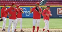  ?? DAVID JABLONSKI/STAFF ?? Reds first baseman Joey Votto takes infield on Opening Day on March 30 at Great American Ball Park in Cincinnati. Votto will continue his rehab from injury in Cincinnati.