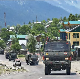  ??  ?? AN ARMY CONVOY moves along the Srinagar-leh National highway in Kashmir’s Ganderbal district on June 17.