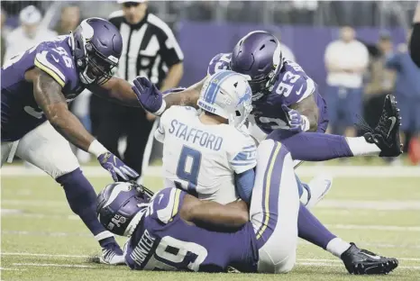  ?? PICTURE: BRUCE KLUCKHOHN/AP ?? 0 Detroit Lions quarterbac­k Matthew Stafford is sacked by the Minnesota Vikings defence.