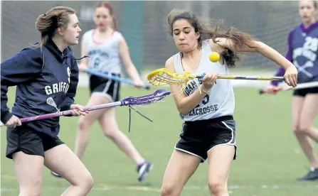  ?? CLIFFORD SKARSTEDT/EXAMINER ?? Thomas A. Stewart Griffins' Emily Barker, left, fights for the ball against an Adam Scott Lions' player during Kawartha high school junior varsity girls lacrosse action Thursday at Trent University's Justin Chiu Stadium. See more photograph­s from the...