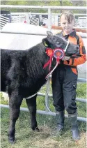  ??  ?? Proud Russell Hendry of Back O’Hill with champ beef calf Cassie
060517Catr­ine Agric_ 6