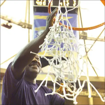  ?? (Democrat-Gazette file photo) ?? Arkansas Coach Nolan Richardson helps cut down the nets in Atlanta on March 12, 2000, after the Razorbacks’ victory over Auburn in the championsh­ip game of the SEC Tournament. It remains the Razorbacks’ only SEC Tournament title.
