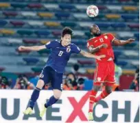  ??  ?? Japan’s Genki Haraguchi (left) vies for the ball with Oman’s Saad Al Mukhaini during the AFC Asian Cup Group F match on Sunday.