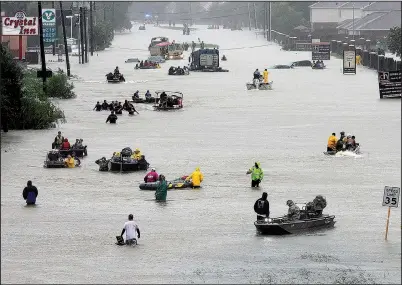  ?? AP/DAVID J. PHILLIP ?? Water continues to rise Monday in Houston as rescue boats fill a flooded street to pick up people stranded by Harvey.