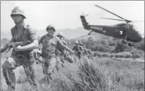  ?? EDDIE ADAMS, ASSOCIATED PRESS FILE PHOTO ?? U.S. Marine infantry stream into a suspected Viet Cong village in 1965 near Da Nang in Vietnam during the Vietnamese war.