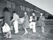  ?? The Chronicle 1942 ?? Japanese American children from the Tanforan internment camp in San Bruno board a train for a camp in Utah in 1942.