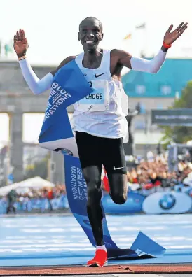  ?? /Reuters ?? Moment of greatness: Eliud Kipchoge crosses the finish line in Berlin, where he shattered the marathon world record, clocking 2hr 1min 39sec for the 42km route.