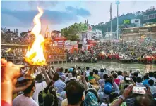  ?? Photo: AFP ?? Thousands of people gather during evening prayers on the banks of the Ganges River in Haridwar, India. The river is seen as a living goddess.