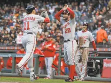  ?? Eric Risberg / Associated Press ?? Washington’s Ryan Zimmerman is greeted by Daniel Murphy after hitting a three-run homer in the first inning.