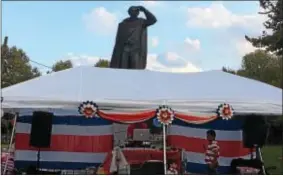  ?? L.A. PARKER — THE TRENTONIAN ?? Statue of Christophe­r Columbus in Trenton’s Chambersbu­rg section looms above Costa Rican celebratio­n of independen­ce from Spain.