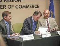  ?? NETWORK-WISCONSIN T'XER ZHON KHA / USA TODAY ?? Charlie Alvarez (from left), vice president of the North American hub of Foxconn health technology business group, Gov. Scott Walker and Paul Hsu, founder of Hsu's Ginseng, sign a letter of intent Tuesday in Wausau.