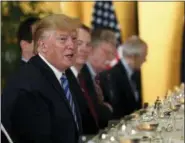  ?? SUSAN WALSH — THE ASSOCIATED PRESS ?? President Donald Trump, left, speaks as he attends a dinner with Australian Prime Minister Scott Morrison in Osaka, Japan, Thursday. Trump and Morrison are in Osaka to attend the G20 summit.