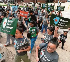 ?? THOMAS J. TURNEY/USA TODAY NETWORK ?? People march in support of the Supplement­al Nutrition Assistance Program on April 14 in Springfiel­d, Illinois.