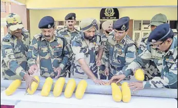  ?? HT FILE ?? Border Security Force officials showing 11kg heroin seized from Ramkot border outpost in Amritsar sector this year.