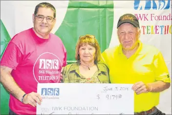  ?? KATIE SMITH/THE GUARDIAN ?? Mike MacKenzie, left, P.E.I.’s community chair of the IWK Telethon for Children, receives a cheque from donors Bonnie and Gar Gillis at the Murphy’s Community Centre telethon site in Charlottet­own. This year’s telethon raised a recordbrea­king...