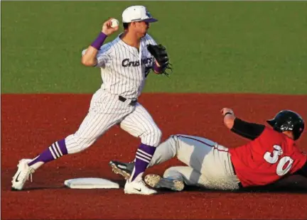  ?? RANDY MEYERS — THE MORNING JOURNAL ?? Crushers infielder Jordan Dean forces out Washington’s Kane Sweeney at second base and tries to turn the double play.