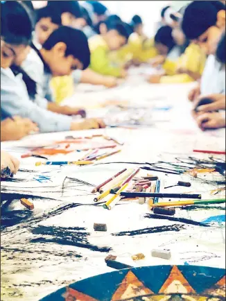  ??  ?? Children poring over their work either alone or under the supervisio­n of an experience­d instructor.