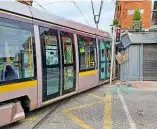  ?? BOTH: DUBLIN FIRE BRIGADE ?? Right: The collision caused damage to traffic lights and the façade of McGettigan’s Bar on Queen Street as the rear end of the leading car left the rails.