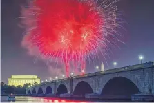  ?? J. DAVID AKE/ASSOCIATED PRESS ?? Fireworks burst over the Memorial Bridge during Independen­ce Day celebratio­ns on the National Mall in Washington on Tuesday.