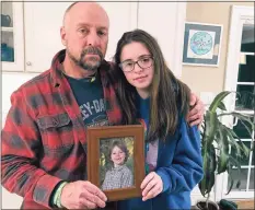  ?? Associated Press file photo ?? Mark Barden and his daughter Natalie Barden hold a photograph of Natalie’ late brother, Daniel, who died on the Dec. 14, 2012, Sandy Hook Elementary School shooting.