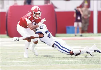  ?? Justin Casterline / Getty Images ?? Indiana’s Ty Fryfogle is tackled by UConn’s Omar Fortt at Memorial Stadium on Sept. 21, 2019 in Bloomingto­n, Indiana.