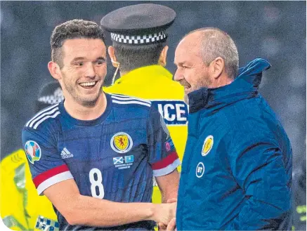  ??  ?? It was smiles all round for John McGinn and Steve Clarke during the recent win over Kazakhstan