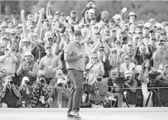  ?? Charlie Riedel / Associated Press ?? Patrick Reed celebrates after sinking a 3-foot putt on the 18th hole to secure the Masters title after a big final push by Rickie Fowler.