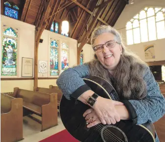  ?? FRANK GUNN, THE CANADIAN PRESS ?? Musician Colleen Newell holds her guitar at St. Saviour’s Anglican Church in Toronto. It’s long been known that Alzheimer’s patients often retain musical memories, even when recall of names, faces and places has been lost as the disease relentless­ly destroys key areas of the brain.