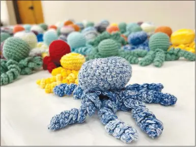  ?? (NWA Democrat-Gazette/Lynn Kutter) ?? Hospitals use these crocheted or knitted octopuses with babies in a neonatal unit. A baby can latch onto the tentacles, instead of grabbing onto a breathing or feeding tube or an IV line.