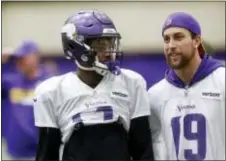  ?? THE ASSOCIATED PRESS ?? Minnesota’s Stefon Diggs, left, chats with fellow wide receiver Adam Thielen during practice on Wednesday. Diggs has had his ups and downs throughout his life and career, but there’s been no greater high on the field than his 61-yard TD reception on...