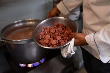  ?? RITA HARPER — THE NEW YORK TIMES ?? The chef Zoe Chase, Leah Chase’s great-great granddaugh­ter, prepares Dooky Chase’s signature red beans and rice at the restaurant in New Orleans on March 3.