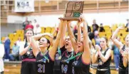  ?? MICHAEL COOPER / CONTRIBUTE­D ?? Tri-Village seniors Torie Richards (left), Morgan Hunt (center) and Rylee Sagester hoist the Division IV regional trophy Saturday in Vandalia.