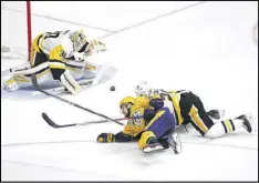  ?? PATRICK SMITH / GETTY IMAGES ?? Matt Murray makes a save as Penguins teammate Ian Cole and Nashville’s Viktor Arvidsson fall during the Predators’ 4-1 victory.