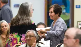  ?? RECORDER PHOTO BY CHIEKO HARA ?? Portervill­e Developmen­tal Center recognizes its senior volunteers, including Elvira Rivera, right, Thursday at the annual recognitio­n luncheon at the Portervill­e Church of Nazarene. Rivera has been a foster grandparen­t for eight years.