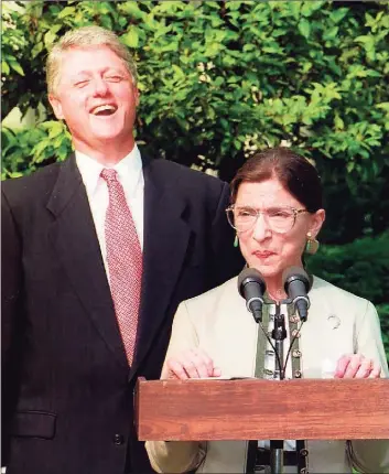  ?? J. David ke / AFP via Getty Images file photo ?? In this photo taken on Aug. 02, 1993 President Bill Clinton laughs as newly confirmed U.S. Supreme Court Justice Ruth Bader Ginsburg stepped up to speak in the Rose Garden at the White House.