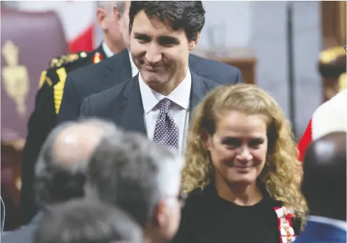  ?? SEAN KILPATRICK / THE CANADIAN PRESS FILES ?? Prime Minister Justin Trudeau follows Gov. Gen. Julie Payette as she leaves the Senate Chamber following the throne
speech late in 2019. A conspiracy by both offices could keep a rogue PM in office unwarrante­dly.