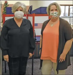  ??  ?? Director Michelle Wilcox and Deputy Director Mandy Frank stand near an in-person voting area at the Auglaize County Board of Elections office on Tuesday. Early in-person voting kicked off April 6 and is available prior to the election date during office hours.