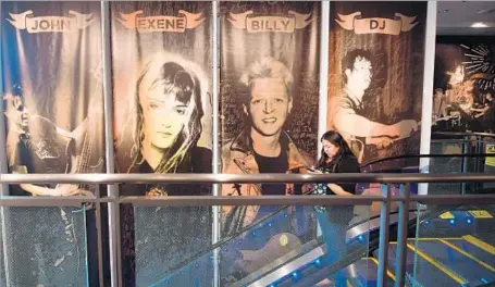  ?? Frederic J. Brown AFP / Getty Images ?? GIANT images of X’s members — John Doe, Exene Cervenka, Billy Zoom and DJ Bonebrake — greet visitors to Grammy Museum exhibit.