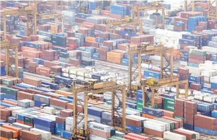  ?? AP FOTO ?? WEAK ECONOMY. Containers are seen at a port in Singapore. The World Trade Organizati­on expects volumes of traded goods to rise 1.2 percent in 2019, well below the 2.6 percent estimate it issued in April and the weakest growth rate for world trade since 2009.