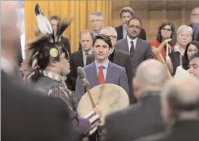  ?? The Canadian Press ?? Prime Minister Justin Trudeau hugs a drummer following a performanc­e after delivering a statement of exoneratio­n on behalf of the Government of Canada to the Tsilhqot'in Nation and the descendant­s of six Tsilhqot'in Chiefs in the House of Commons on...