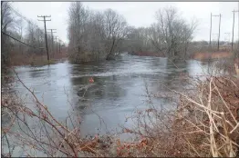  ??  ?? The swollen Pawtuxet River, as seen off Wellington Avenue in Cranston, remains above flood stage.