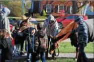  ?? LEAH MCDONALD - ONEIDA DAILY DISPATCH ?? Children pet horses at the Oneida Public Library on Saturday, Nov. 11, 2017, during a program about animals that went to war.