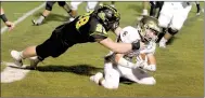  ?? MARK HUMPHREY ENTERPRISE-LEADER ?? Prairie Grove senior middle linebacker Dustin Burton brings down a Shiloh Christian runner inside the 10. The Tigers forced the Saints to turn the ball over on downs five times in the first half. The defensive stops loomed huge in Prairie Grove’s 35-21...