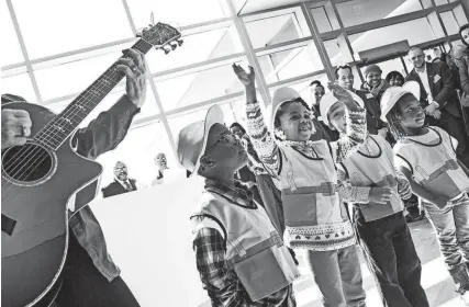  ?? THE COMMERCIAL APPEAL FILES ?? Feb. 10, 2017: From left, Courtney Aldridge, 4, Cayden Malone, 4, Camron Rodgers, 4, and Chloe Coppage, 3, sing along with Claire Valine, a board member and volunteer music teacher, during the Porter-leath Early Childhood Academy grand opening.