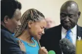  ?? MATT ROURKE/AP ?? Kamilah Whitfield (center), a granddaugh­ter of Buffalo victim Ruth Whitfield, at a news conference in Buffalo, N.Y., Monday.