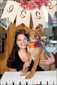  ?? Arkansas Democrat-Gazette/CARY JENKINS ?? Melody Allenswort­h-James poses with her foster dog, Bloomy, in a kissing booth at a recent adoption event held at Hollywood Feed in North Little Rock.