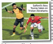  ??  ?? Salford’s Ibou Touray takes on Tristan Abrahams