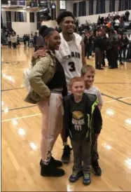  ?? MARISSA MCNEES — THE MORNING JOURNAL ?? Devon Grant poses with fans after Lorain defeated BereaMidpa­rk in a sectional final March 2.